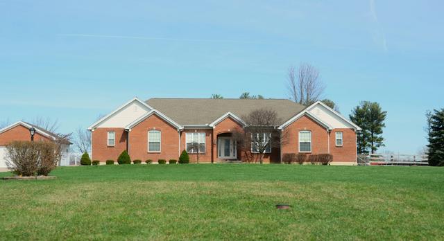 Single story brick home set back on a wide lawn