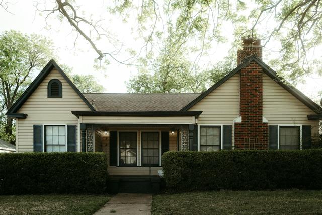 Older cottage style home with a brick chimney