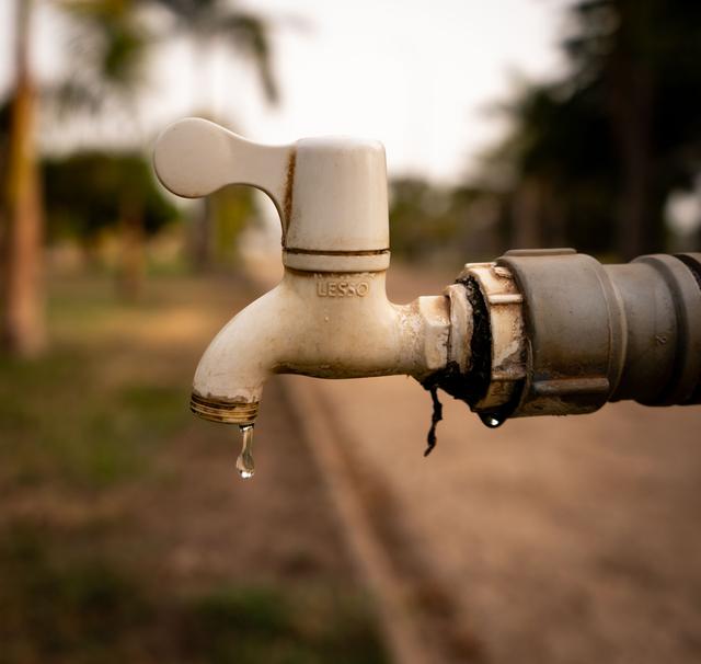 Water dripping from a leaking outdoor hose bib