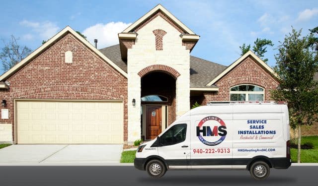 HMS service van parked outside a neighborhood home