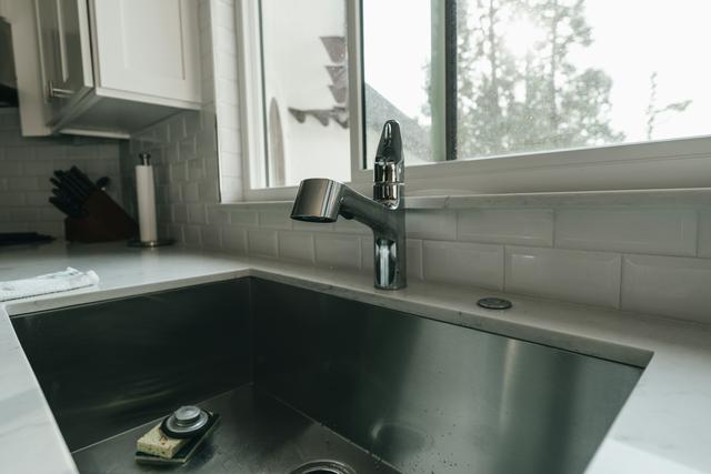 Undermount kitchen sink and faucet below a window