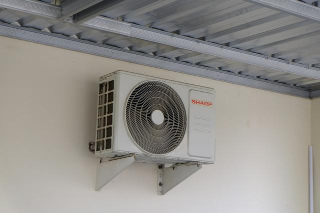 Mini split outdoor unit mounted on a wall bracket