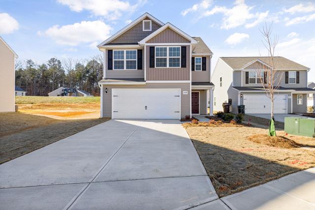Newly built two story home with a fresh concrete driveway