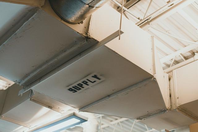 Sheet metal supply duct running along a ceiling