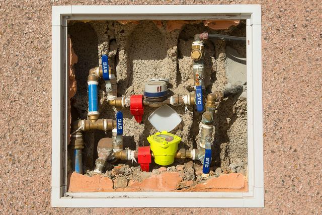 Water meter and shutoff valves inside a wall box